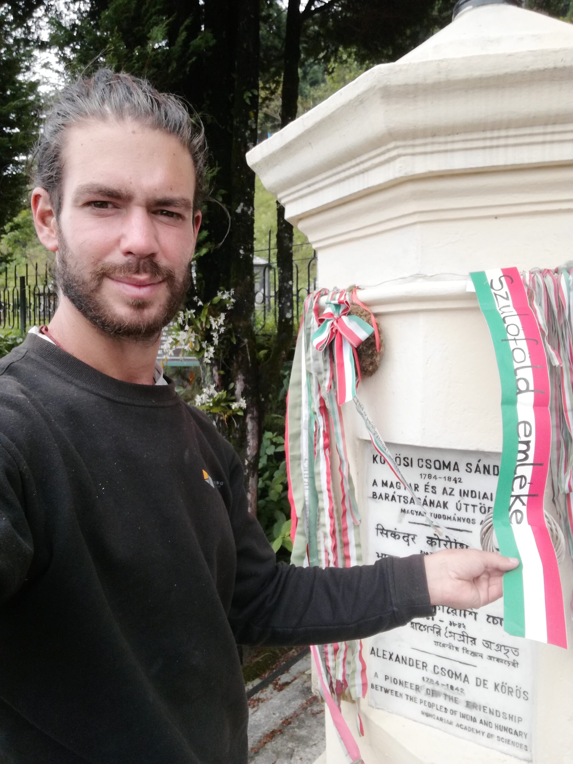 Viktor Zichó placing the red, white, and green ribbons